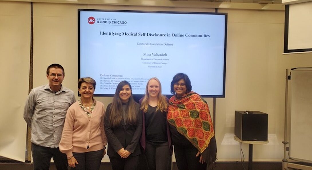 Mina and four of her committee members in front of her slideshow after her defense